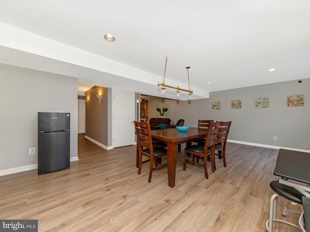 dining room featuring recessed lighting, baseboards, and light wood-style floors