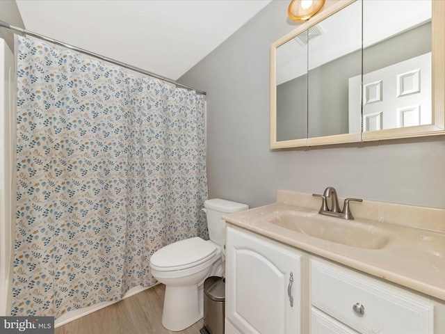 full bathroom featuring visible vents, toilet, a shower with shower curtain, wood finished floors, and vanity