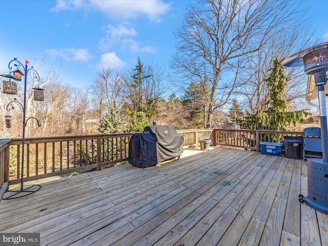 wooden terrace with a grill