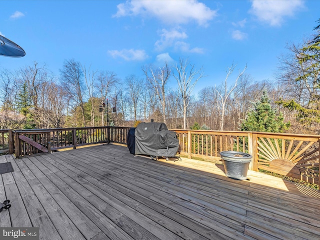 wooden deck featuring area for grilling