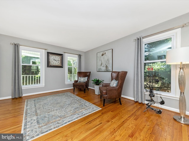 living area featuring light wood-type flooring and baseboards