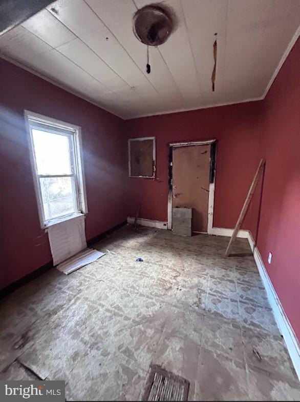 unfurnished room featuring baseboards