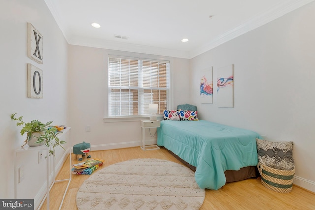 bedroom featuring recessed lighting, visible vents, ornamental molding, wood finished floors, and baseboards