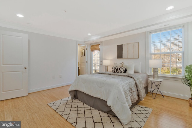 bedroom with light wood-style floors, multiple windows, ornamental molding, and visible vents