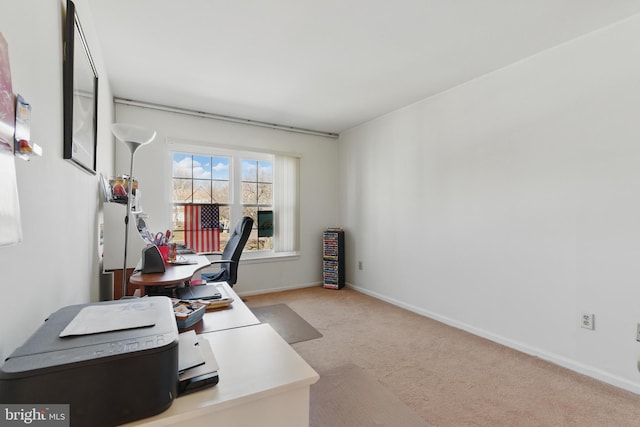 carpeted office space featuring baseboards