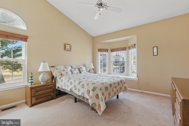 bedroom featuring a ceiling fan, visible vents, baseboards, high vaulted ceiling, and light colored carpet