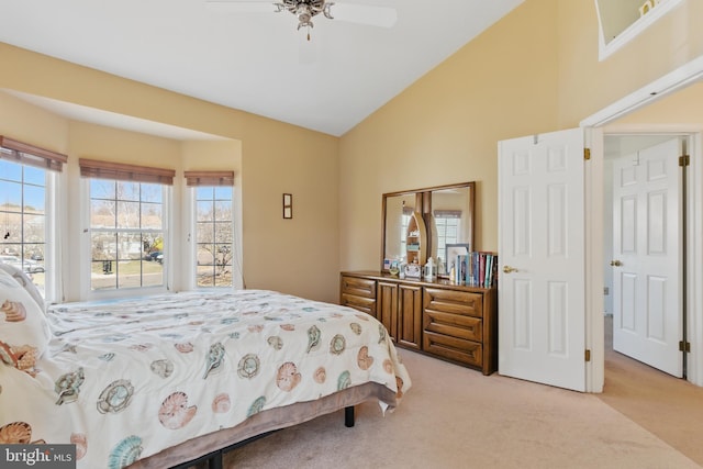 bedroom with multiple windows, light carpet, and high vaulted ceiling