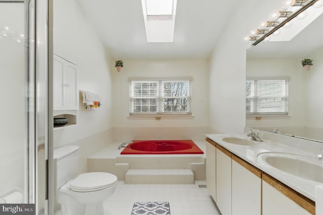 full bath featuring a healthy amount of sunlight, a skylight, and a sink