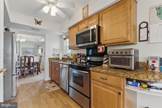 kitchen featuring visible vents, light wood-type flooring, a sink, appliances with stainless steel finishes, and a toaster