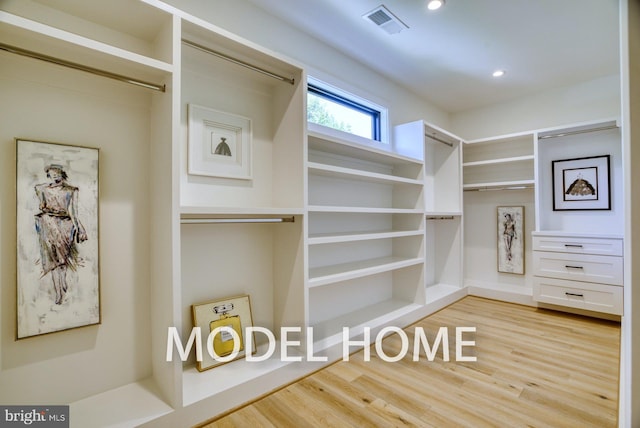 spacious closet featuring light wood-style floors and visible vents