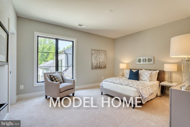 bedroom featuring baseboards, visible vents, and light colored carpet