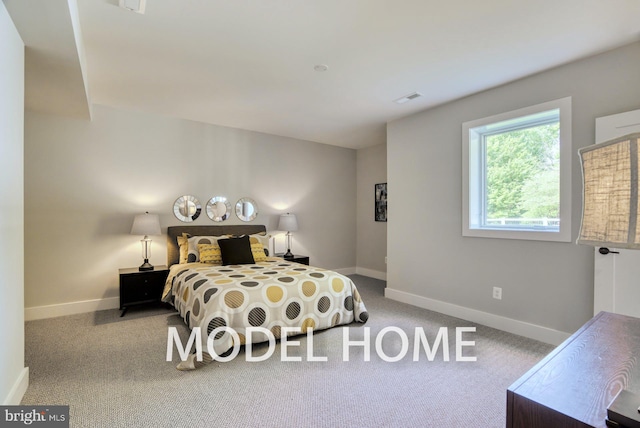 carpeted bedroom with baseboards and visible vents