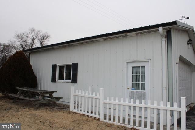 view of home's exterior featuring fence