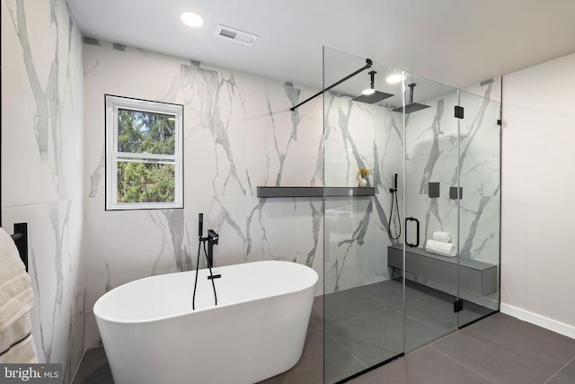 full bathroom featuring a freestanding tub, a marble finish shower, visible vents, and recessed lighting