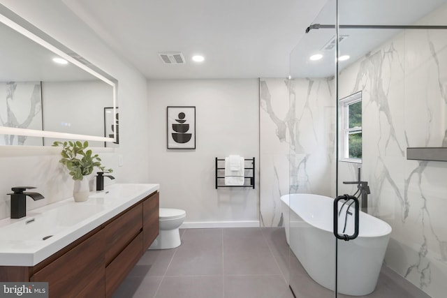 full bathroom with double vanity, a soaking tub, visible vents, and a sink