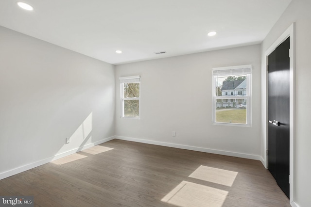 spare room with a healthy amount of sunlight, visible vents, and baseboards