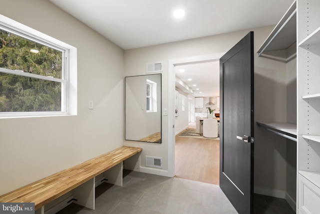 mudroom with recessed lighting, visible vents, baseboards, and tile patterned floors