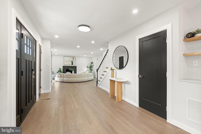 entrance foyer with light wood-style flooring, stairway, visible vents, and recessed lighting