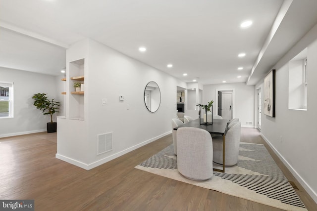 dining room with baseboards, visible vents, wood finished floors, and recessed lighting