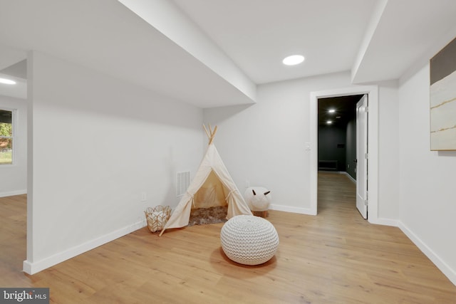 rec room featuring baseboards, recessed lighting, visible vents, and light wood-style floors