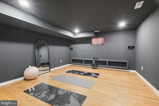 exercise room with recessed lighting, baseboards, and wood finished floors