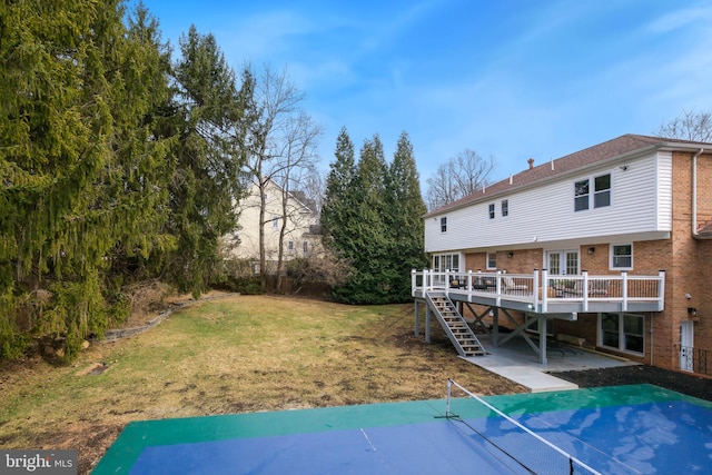 view of yard featuring stairway, a patio, and a wooden deck