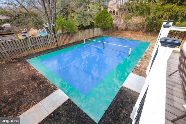 view of pool with a tennis court and fence