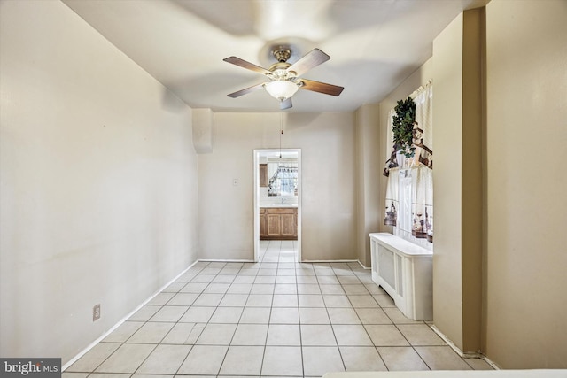 spare room featuring a ceiling fan and light tile patterned flooring