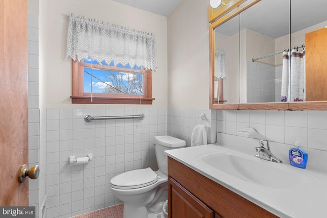 bathroom featuring toilet, a shower, tile walls, and vanity