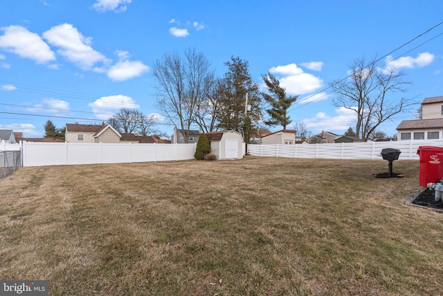 view of yard featuring a fenced backyard, an outdoor structure, and a shed