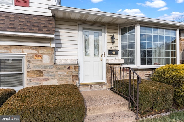 view of exterior entry featuring stone siding