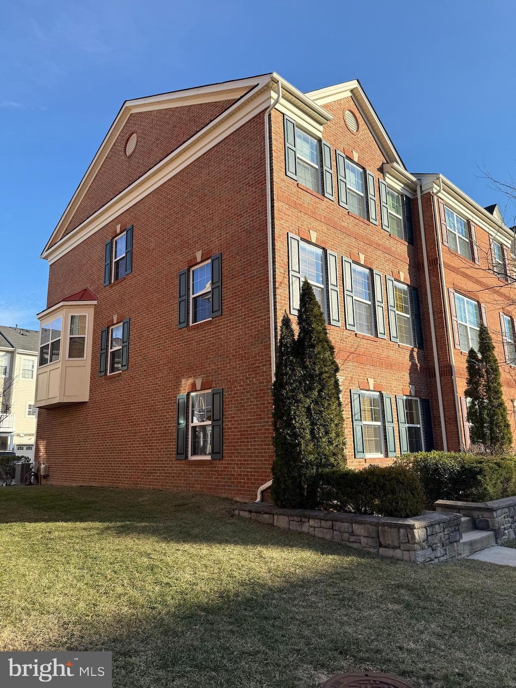 view of home's exterior featuring a yard and brick siding