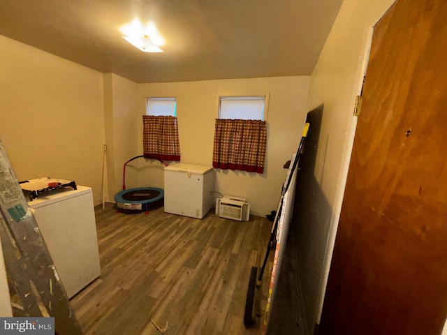 clothes washing area featuring washer / dryer and wood finished floors