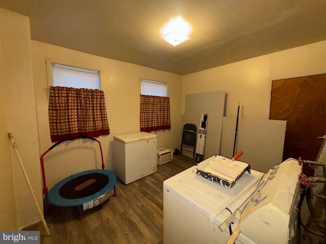 washroom featuring washer and dryer, laundry area, and wood finished floors