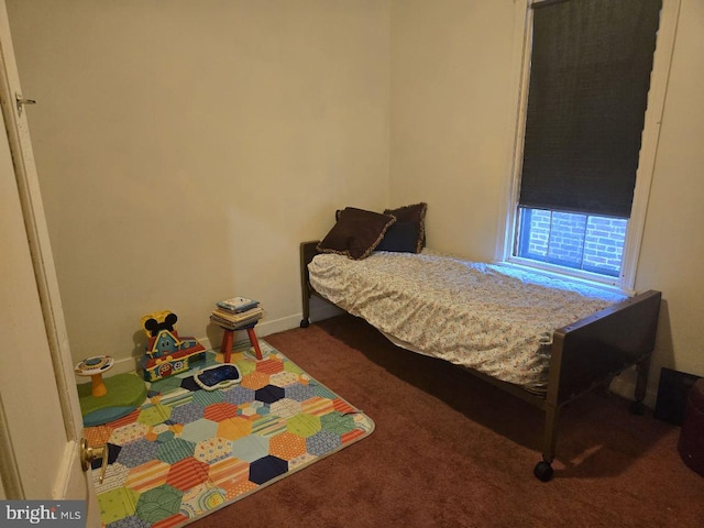 bedroom with carpet flooring and baseboards