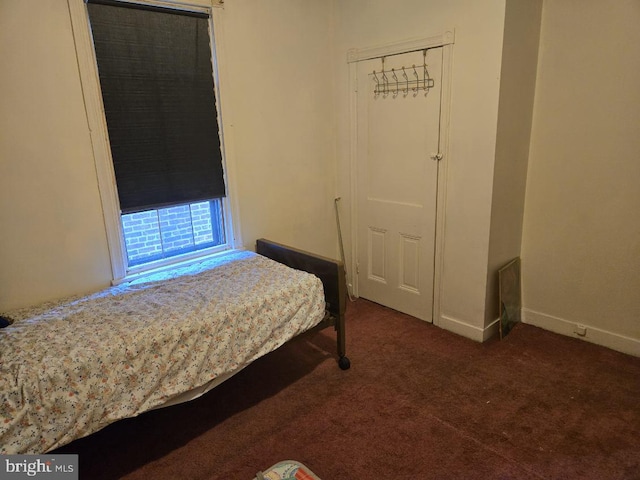 carpeted bedroom featuring baseboards