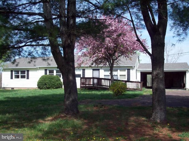 view of front of home featuring a deck, crawl space, and a front yard