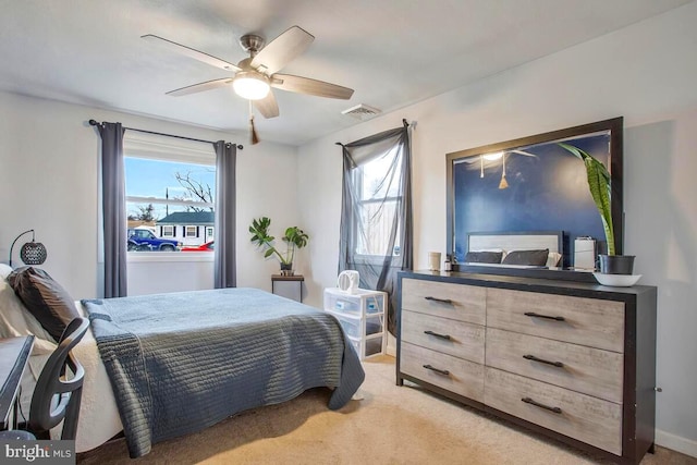 bedroom featuring light carpet, multiple windows, and visible vents