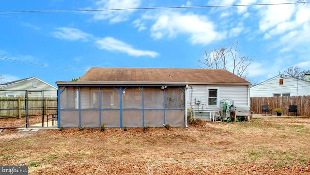 back of house featuring a sunroom and fence