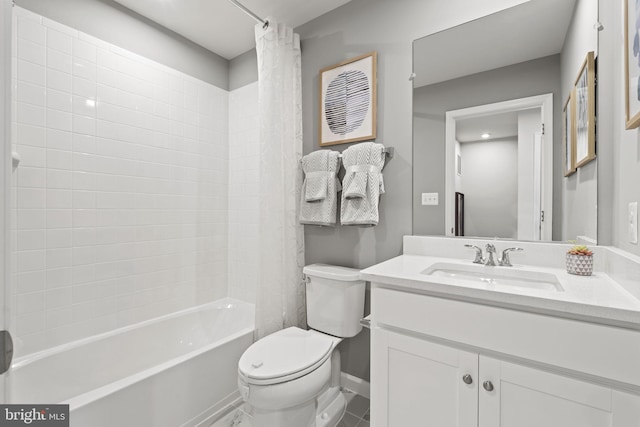 bathroom with shower / bath combo, baseboards, vanity, and toilet