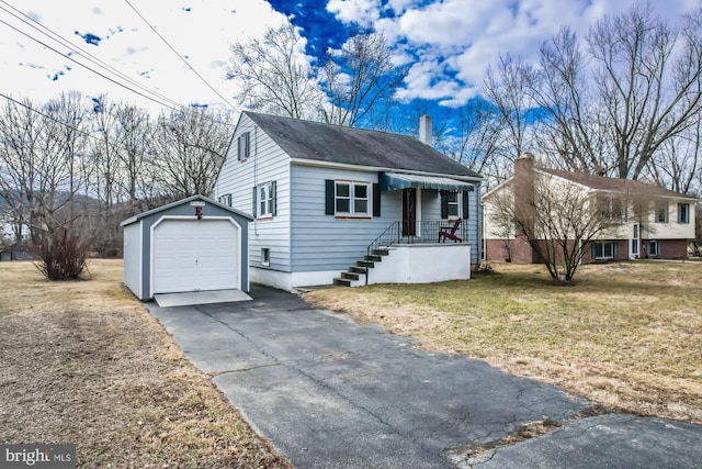 view of front of house with a garage, a chimney, aphalt driveway, an outdoor structure, and a front yard