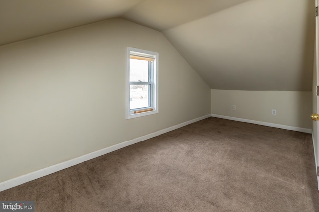 bonus room featuring baseboards, vaulted ceiling, and carpet flooring