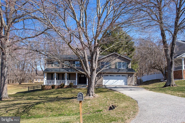 view of front of house featuring a porch, fence, a front lawn, and aphalt driveway