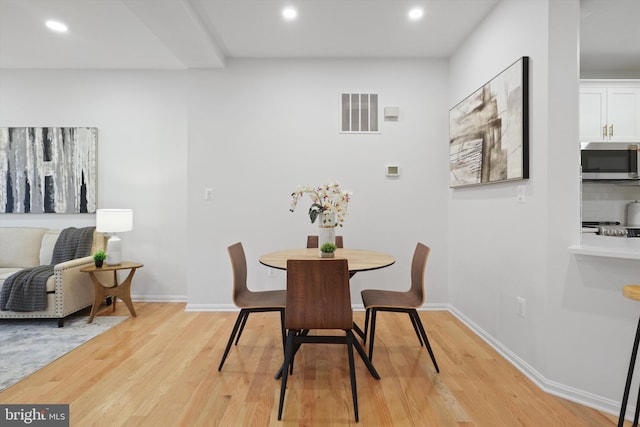 dining space with recessed lighting, visible vents, light wood finished floors, and baseboards