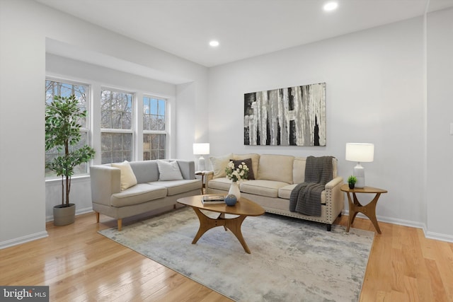 living area featuring recessed lighting, baseboards, and light wood finished floors