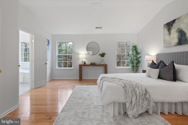 bedroom featuring visible vents, baseboards, and light wood-style floors