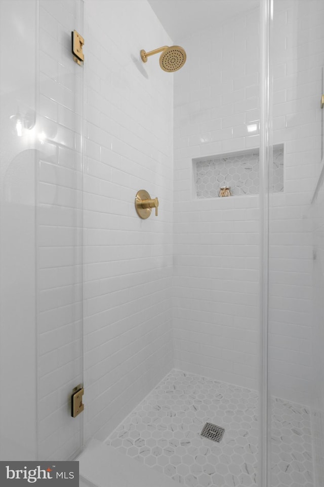 full bath featuring a shower stall