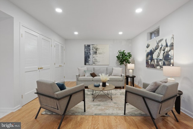 living room with recessed lighting, baseboards, and wood finished floors