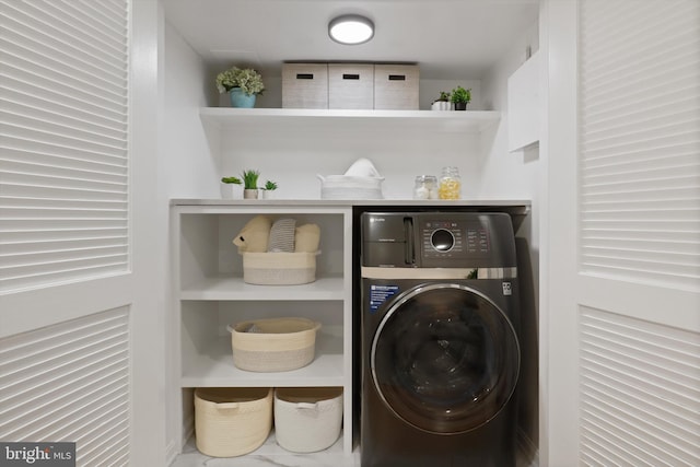 clothes washing area with washer / dryer