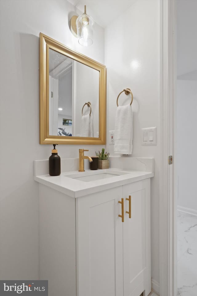 bathroom with marble finish floor and vanity